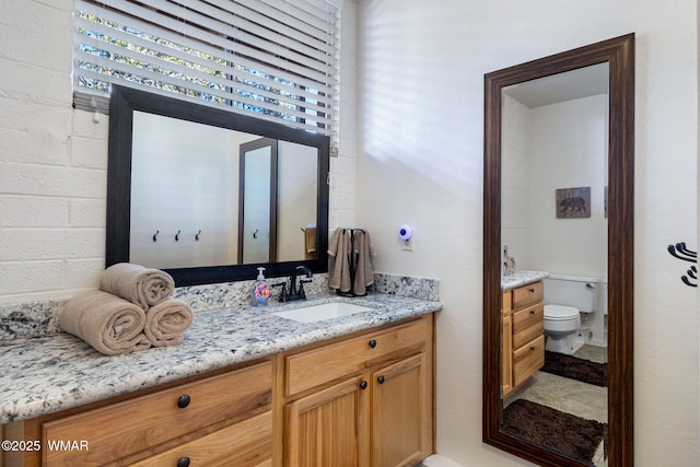 bathroom with vanity and toilet