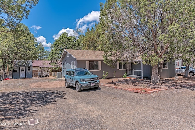 view of front of house with a storage shed and an outdoor structure