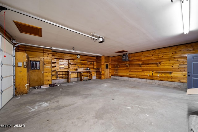 1259 S Penrod Dr, Pinetop, AZ 85935 - garage with a garage door opener, wood walls, and a workshop area