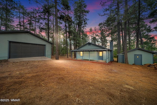 1259 S Penrod Dr, Pinetop, AZ 85935 - view of front of home featuring an outdoor structure, a garage, and a chimney