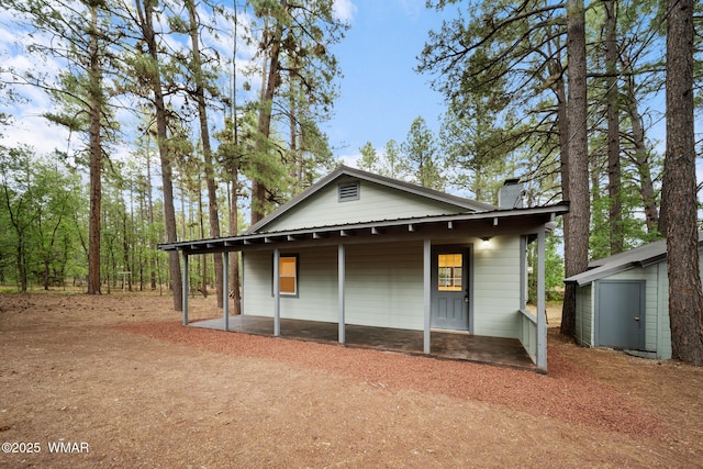 1259 S Penrod Dr, Pinetop, AZ 85935 - view of side of home featuring a chimney and covered porch