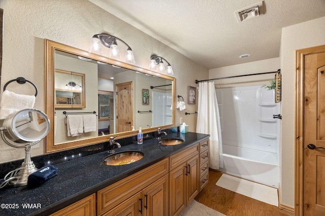 3530 Soaring Eagle Way, Pinetop, AZ 85935 - full bath featuring shower / bathtub combination with curtain, wood finished floors, a textured wall, a textured ceiling, and double vanity