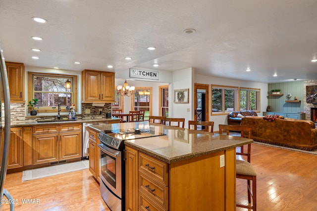 3530 Soaring Eagle Way, Pinetop, AZ 85935 - kitchen featuring appliances with stainless steel finishes, a kitchen breakfast bar, a sink, light wood-style flooring, and recessed lighting