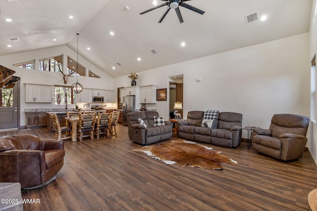 living room featuring high vaulted ceiling, ceiling fan, and dark wood finished floors