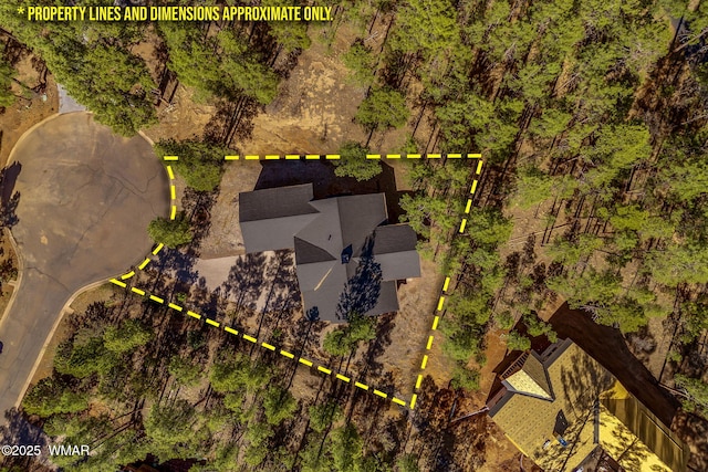 aerial view of property and surrounding area featuring property parcel outlined