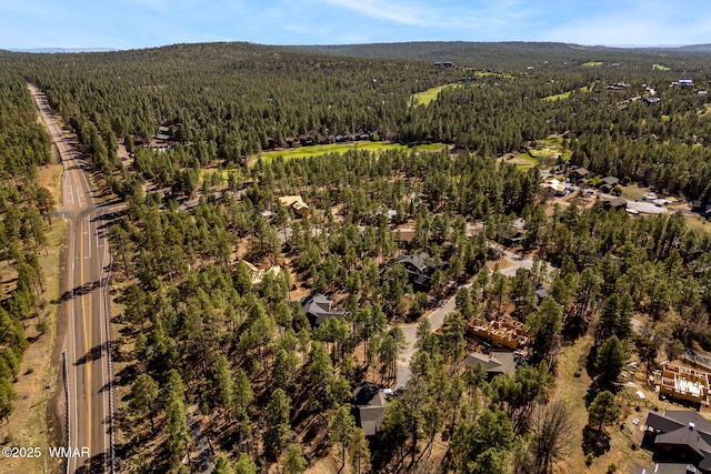 aerial view of property's location featuring a heavily wooded area