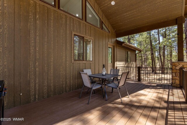 wooden deck featuring outdoor dining space