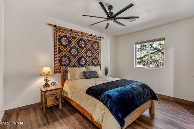 bedroom featuring wood finished floors, baseboards, and ceiling fan