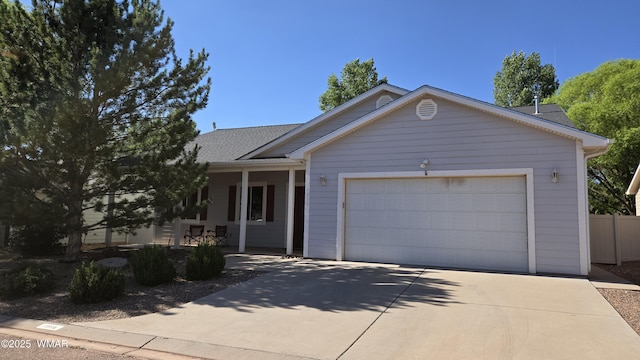 1050 E Jefferson St, Snowflake, AZ 85937 - ranch-style home featuring a garage, a shingled roof, concrete driveway, and covered porch