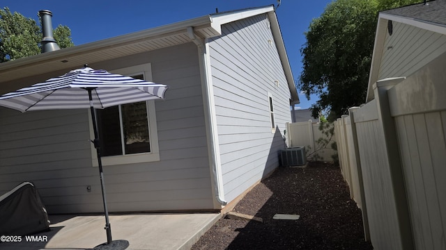 1050 E Jefferson St, Snowflake, AZ 85937 - view of side of home featuring a central AC unit and a patio