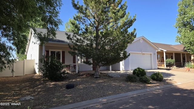 1050 E Jefferson St, Snowflake, AZ 85937 - view of property hidden behind natural elements with a garage, concrete driveway, and a porch