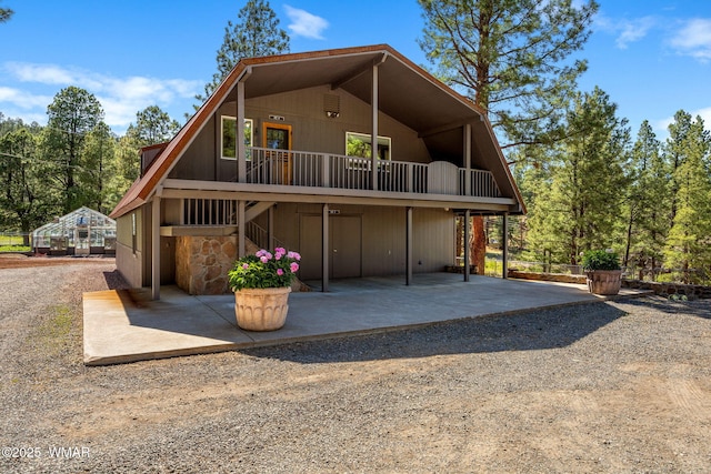 38684 State Route 373, Greer, AZ 85927 - a-frame style home with a patio area, stairway, and stone siding