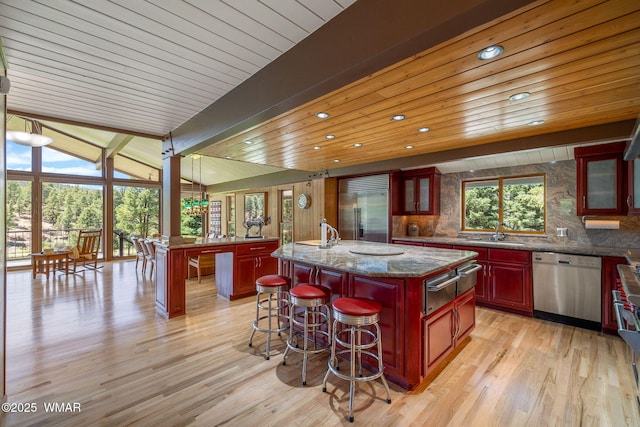 38684 State Route 373, Greer, AZ 85927 - kitchen with appliances with stainless steel finishes, dark brown cabinets, a warming drawer, a center island, and wooden ceiling