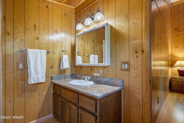 38684 State Route 373, Greer, AZ 85927 - bathroom featuring vanity, wood walls, and wood finished floors