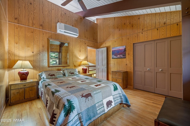 38684 State Route 373, Greer, AZ 85927 - bedroom featuring a wall unit AC, wooden walls, beamed ceiling, wood finished floors, and a closet