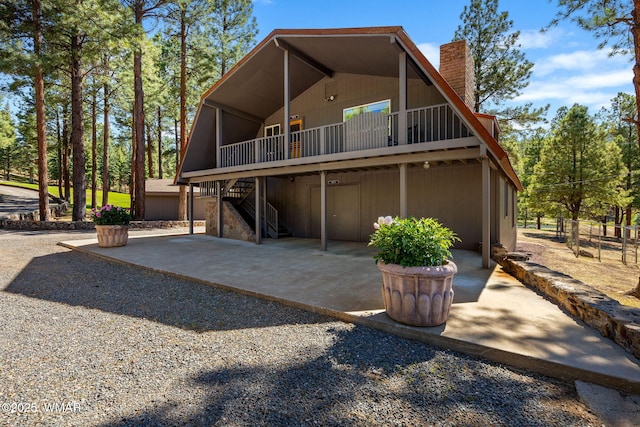 38684 State Route 373, Greer, AZ 85927 - view of front of home featuring a chimney, stairway, a patio area, and a wooden deck