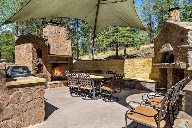 38684 State Route 373, Greer, AZ 85927 - view of patio featuring an outdoor stone fireplace and outdoor dining space