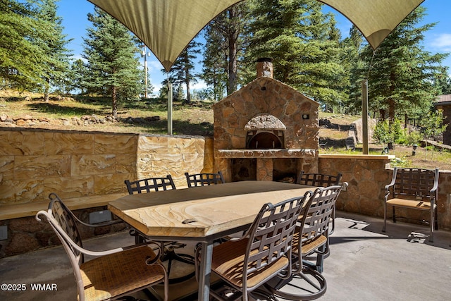 38684 State Route 373, Greer, AZ 85927 - view of patio / terrace with a fireplace and outdoor dining space
