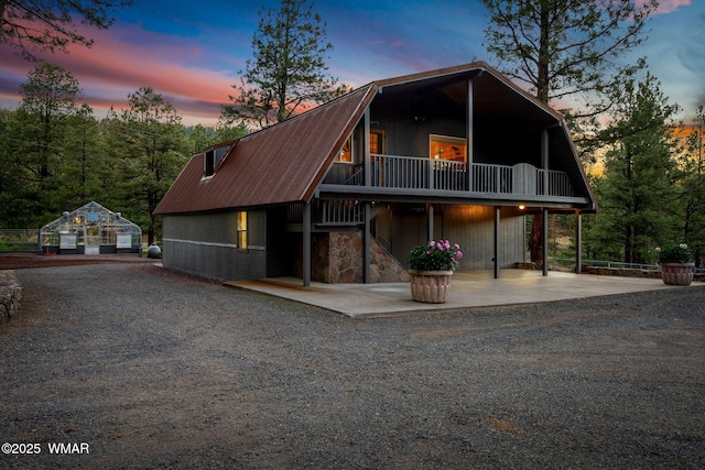 38684 State Route 373, Greer, AZ 85927 - a-frame home with a gambrel roof, a wooden deck, and a metal roof