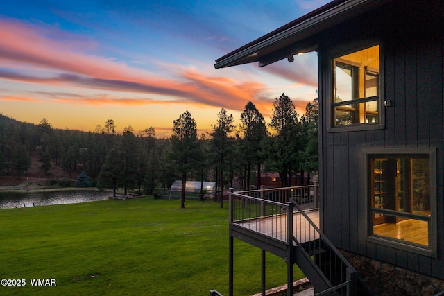 38684 State Route 373, Greer, AZ 85927 - yard at dusk featuring a lawn, stairs, and a deck with water view