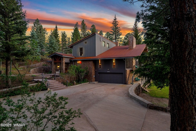 38684 State Route 373, Greer, AZ 85927 - view of front of property featuring stairs, concrete driveway, an attached garage, a chimney, and a porch