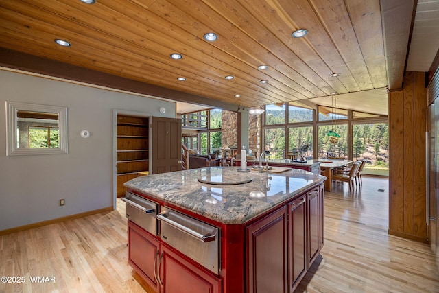 38684 State Route 373, Greer, AZ 85927 - kitchen with a warming drawer, wooden ceiling, recessed lighting, dark brown cabinets, and light wood-style floors