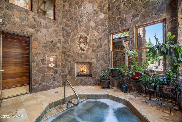 38684 State Route 373, Greer, AZ 85927 - interior space with an in-ground hot tub and a stone fireplace