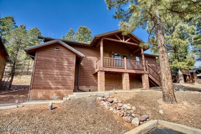 rustic home with a balcony and crawl space