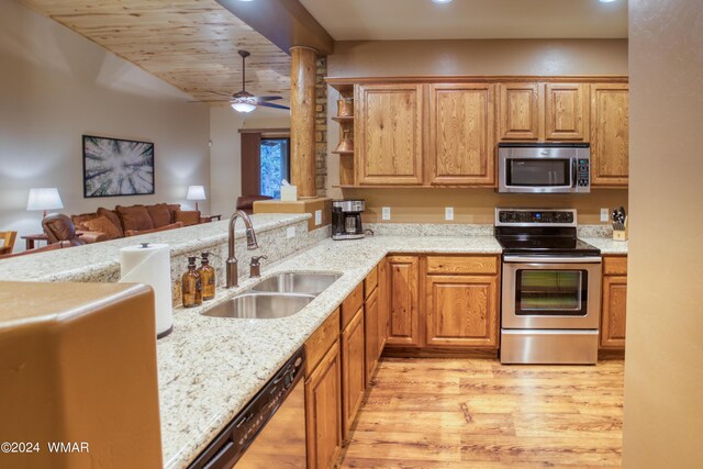 3240 W Black Oak Loop, Show Low, AZ 85901 - kitchen featuring appliances with stainless steel finishes, light wood-style floors, a sink, and light stone countertops