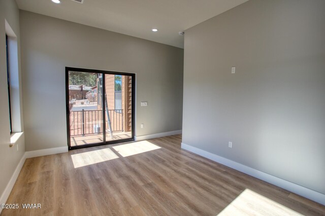 4696 W Tatanka Loop, Show Low, AZ 85901 - unfurnished room with wood finished floors, baseboards, and recessed lighting