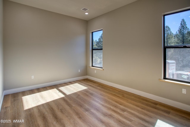 4696 W Tatanka Loop, Show Low, AZ 85901 - unfurnished room featuring wood finished floors, baseboards, and recessed lighting