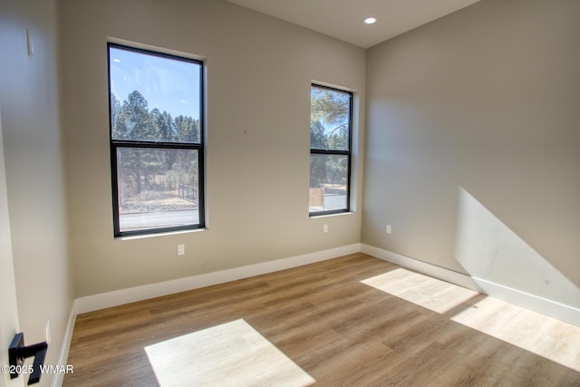 4696 W Tatanka Loop, Show Low, AZ 85901 - unfurnished room with wood finished floors, baseboards, and recessed lighting
