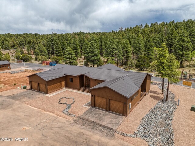 4696 W Tatanka Loop, Show Low, AZ 85901 - aerial view of property and surrounding area featuring a heavily wooded area