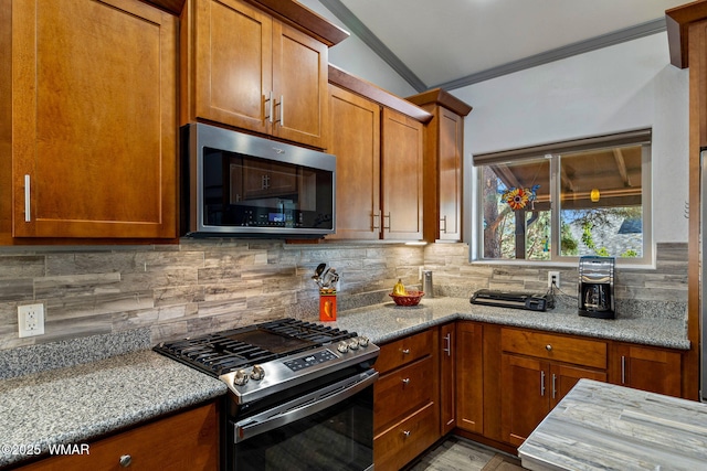 721 S Reynolds Ln, Show Low, AZ 85901 - kitchen with stainless steel appliances, crown molding, light stone counters, brown cabinetry, and decorative backsplash