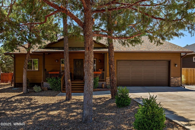 721 S Reynolds Ln, Show Low, AZ 85901 - view of front of home with concrete driveway, an attached garage, covered porch, and roof with shingles