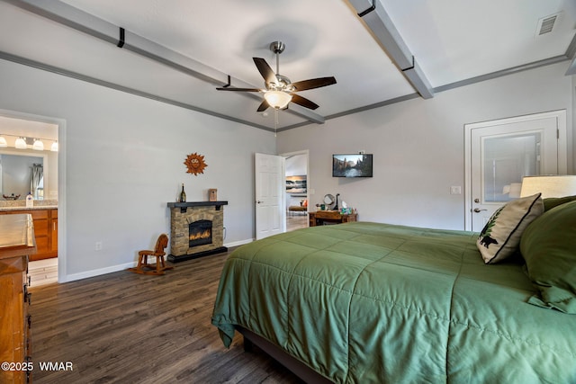721 S Reynolds Ln, Show Low, AZ 85901 - bedroom featuring vaulted ceiling, dark wood-type flooring, a stone fireplace, ensuite bath, and ceiling fan