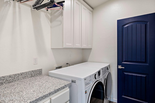 laundry area featuring cabinet space and washing machine and dryer