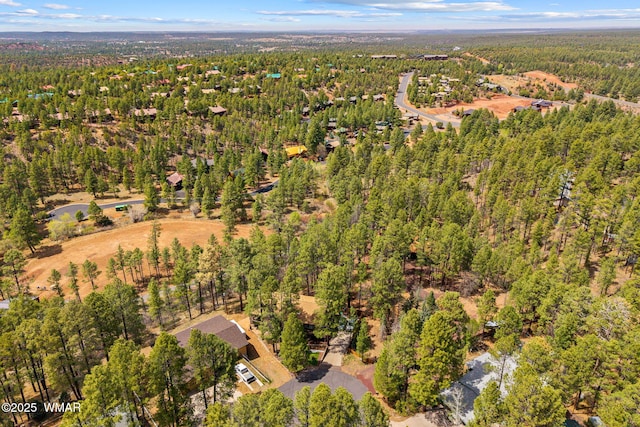 aerial view of property's location featuring a heavily wooded area