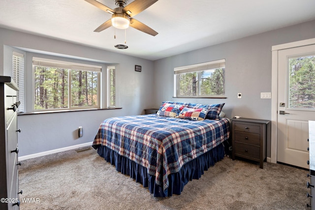 carpeted bedroom featuring baseboards and ceiling fan
