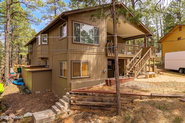 back of house with stairway and a wooden deck