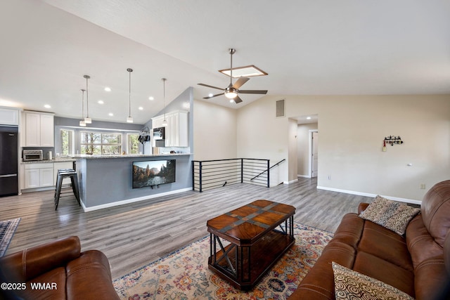 living room with a ceiling fan, dark wood-type flooring, vaulted ceiling, recessed lighting, and baseboards