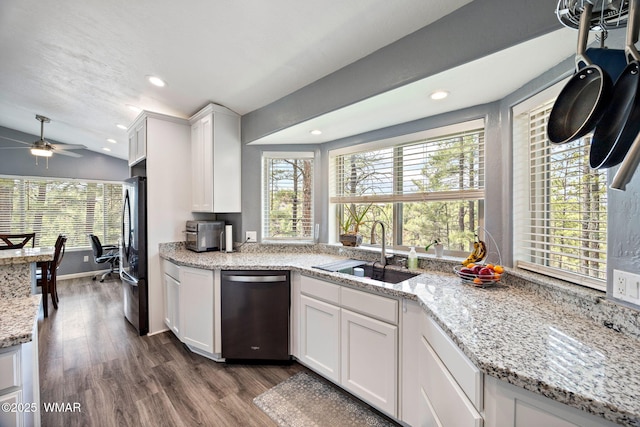 kitchen featuring stainless steel dishwasher, a sink, freestanding refrigerator, dark wood-style floors, and recessed lighting