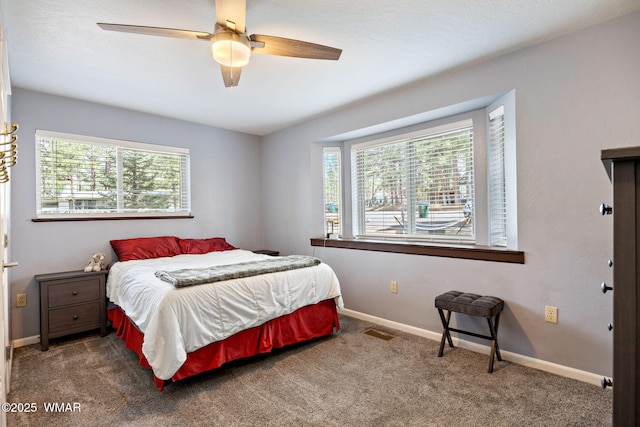 carpeted bedroom with baseboards and ceiling fan