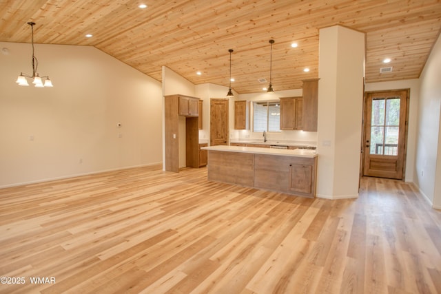 3360 W Mariposa Ln, Show Low, AZ 85901 - kitchen with a chandelier, light wood finished floors, light countertops, a peninsula, and vaulted ceiling