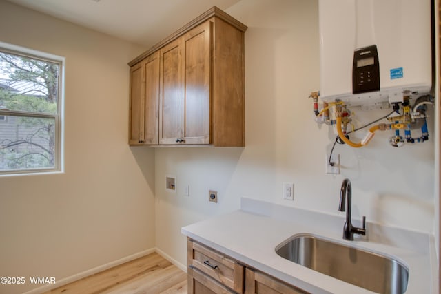 3360 W Mariposa Ln, Show Low, AZ 85901 - laundry area with cabinet space, hookup for an electric dryer, tankless water heater, light wood finished floors, and hookup for a washing machine