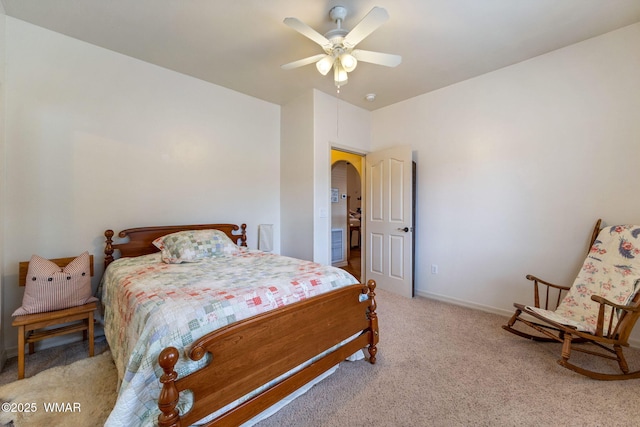 bedroom featuring arched walkways, carpet flooring, ceiling fan, and baseboards