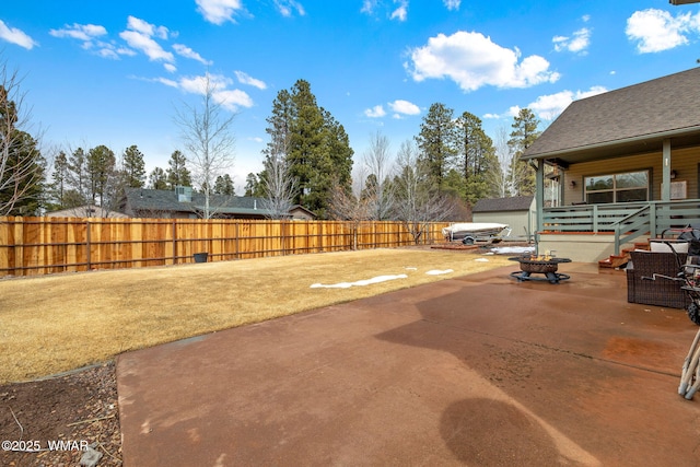 view of patio / terrace with an outdoor fire pit and fence