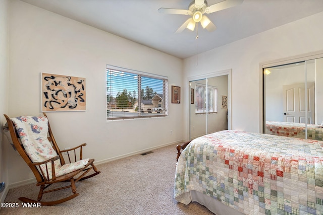 bedroom featuring baseboards, multiple closets, visible vents, and carpet flooring