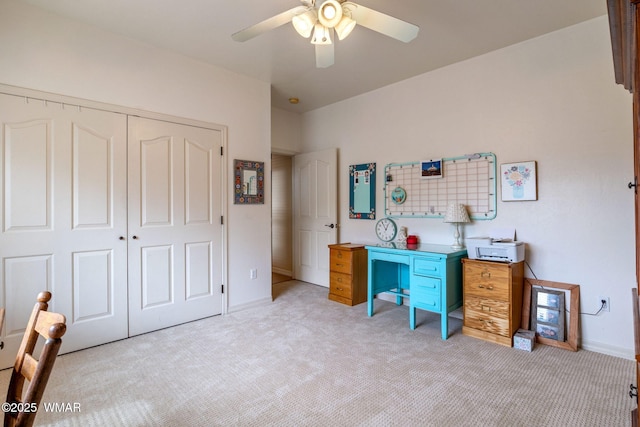 home office with light carpet, baseboards, and a ceiling fan