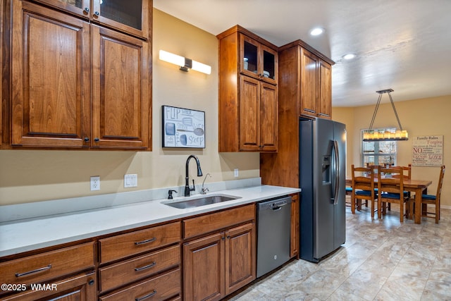 kitchen featuring a sink, dishwashing machine, brown cabinets, and stainless steel fridge with ice dispenser